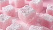 © faiz - Turkish delight cubes dusted with powdered sugar, on a blush pink background, close-up macro shot showing sugary surface.