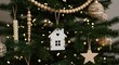 © PrabuanaAndika - Christmas Tree Decorations with Wooden House Ornament and Warm String Lights
