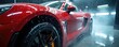 © Maryna - Bright red sportscar gets pro detailing service. Water sprays car body. Shiny vehicle gets covered in water droplets. Modern auto stands inside vehicle service station. Automotive care concept.