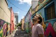 © Роман Заворотный - Man Smiles While Standing in Vibrant Urban Alley Decorated With Street Art
