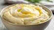 © MIkrom - Creamy Mashed Potatoes With Melted Butter In A Bowl With Soft Lighting And Neutral Background