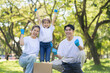 © NINENII - Asian family collects plastic bottles into black bags at a park on the weekend, Sustainable development and innovation green business concept.