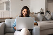 © fizkes - Happy beautiful Hispanic woman using Internet communication