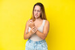 © luismolinero - Young caucasian woman isolated on yellow background suffering from pain in hands