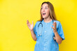 © luismolinero - Young surgeon nurse woman isolated on yellow background with surprise facial expression