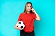 © luismolinero - Young football player woman isolated on blue background having doubts and thinking