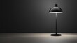 © vadosloginov - Modern black table lamp casting soft light in a minimalist workspace setting