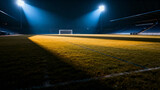 Empty soccer field illuminated by stadium lights at night