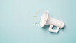 © Anna K@S - White megaphone on pastel blue background with sound waves