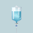 © pinastika - Medical IV fluid bag suspended with clear liquid and tube against a soft blue background viewed from the front
