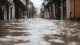 Flooded Street: A scene of rising water levels in a residential neighborhood after torrential rains, showcasing the challenges of urban flooding. Rising waters flow.