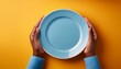 © Amber - image of hands holding empty plate symbolizing food insecurity against vibrant backdrop