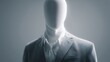 © maxximmm - A faceless mannequin dressed in a suit presents an abstract figure under soft lighting. The suit contours wrap around the mannequin to highlight the minimal form.