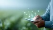 © Firadoaw - Agritech farmer, tablet in hand, virtual icons, agricultural data analysis