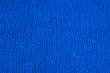 © Olha - Macro shot of blue knitted wool fabric with visible fibers. Soft warm texture perfect for winter fashion, design, or cozy textile backgrounds. Natural yarn material close up.