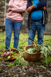 © Paula - Couple standing proudly with baskets full of garden vegetables