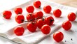 © hari - Fresh Red Cherry Tomatoes Scattered on a White Cloth.