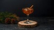 © RZ  - Elegant winter cocktail served in a vintage glass with a cinnamon stick and ice sphere, styled with pine cones and evergreen branches on a rustic wooden slice backdrop