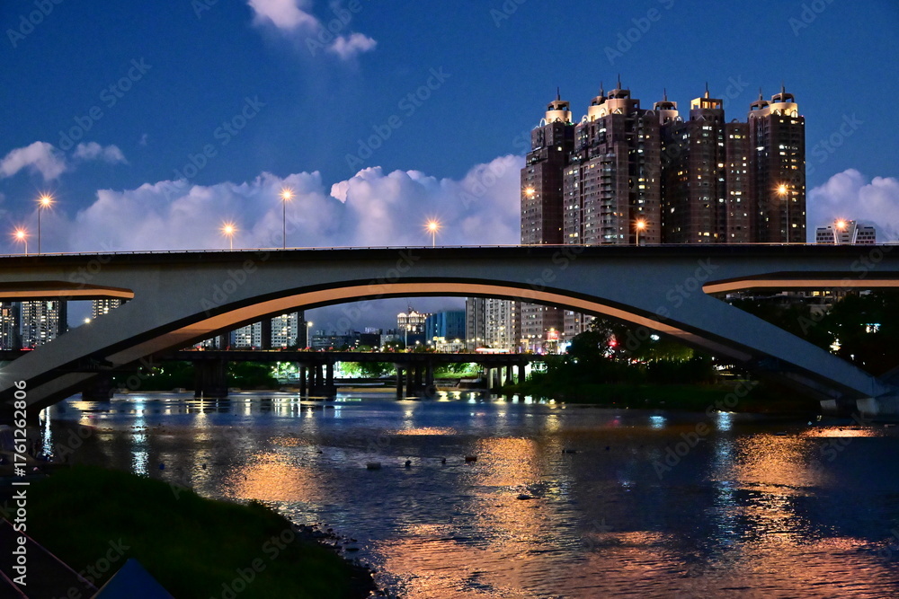 Illuminated arched highway bridge spanning Xindian River at Bitan ...