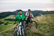 © Halfpoint - Older couple cycling together in nature, smiling and enjoying outdoor adventure.