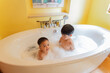 © torwaiphoto - Children playing in the bathroom, in the bathtub