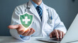 © Nizam - Doctor offers shield with medical cross symbolizing healthcare protection and insurance security