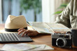 © PheelingsMedia - Tourist planning vacation checking maps and laptop
