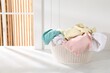 © New Africa - Laundry basket full of clothes on white marble surface indoors, space for text