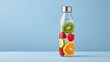 © Preeyanuch - organic parenting habits A glass bottle filled with water and colorful fruit slices on a light blue background.