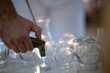 © .shock - Therapist Preparing Glass Cups for Traditional Cupping Therapy. Close up of therapists hands arranging clean glass cups on a tray before starting a traditional cupping therapy session.