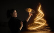 © Rendara Studio - Smiling woman creating glowing Christmas tree with magical touch