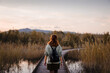 © EduBFoto - Adventurous hiker girl walking on wooden bridge over mountain lake
