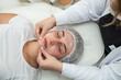 © RomanR - Masseur therapist doing rejuvenating facial massage procedure. Skincare by cosmetician.