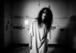 © cato_rium - Woman patient in deserted psychiatric room. Ghostly spirit in an old abandoned asylum or mental hospital. Horror and nightmare concept for Halloween cinema banner template with copyspace.