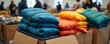 © Vadym - Brightly colored winter jackets are stacked in boxes ready for donation. Volunteers sort apparel for charity to provide warmth and comfort for people in need during cold weather.