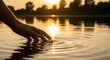© benjamin - A serene moment as a hand gently touches the tranquil surface of a lake, creating ripples and reflecting the warm hues of a setting sun, evoking a sense of calm and connection with nature.
