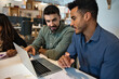 © Xavier Lorenzo - Two young multiracial coworkers collaborating on a laptop while developing a creative project in a modern office environment. Teamwork, innovation and startup culture concept