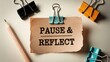 © Muhammad - Inspiring 'Pause & Reflect' message on a note, surrounded by office supplies, perfect for motivation and mindfulness