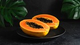 papaya on a black plate