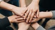 © Arg Studio - Closeup of a group of people stacking hands together in a teamwork concept