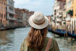 © leo10 - Stunning Venice Canal View from Gondola with Woman in Elegant Hat and Brown Hair.