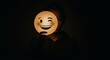 © SYNH STOCK - Person holding illuminated smiley face mask in dark room, expressing playful and mysterious mood with single wink, creating intriguing and symbolic image.