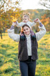 © Kristina89 - Young woman with child playing on a walk. Mother and little daughter in autumn park. Healthy motherhood.