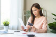 © KMPZZZ - Business financial concept, stressed asian young woman hand checking list with bill for calculate accounting expense credit card payment on due deadline, trying to find money to pay debt on table.