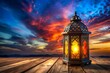 © Osama - An ornate islamic lantern glowing with warm light sits on a rustic wooden surface against a dramatic and colorful sunset sky with vibrant clouds