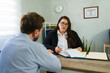 © AntonioDiaz - Lawyer explaining legal document to male client