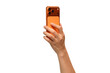 © Pornprasit Panada - Back view of a hand holding a new cosmic orange smartphone, isolated on a transparent PNG.