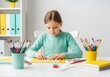 © Anna - A creative young girl painting with watercolors at her desk. Child engaged in an art and craft hobby at home. Childhood education and learning concept