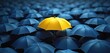 © Pete - One yellow umbrella stands out among many blue umbrellas. Image highlights individuality. Shows how one thing different from others. Suggests uniqueness, standing out from crowd. Yellow umbrella