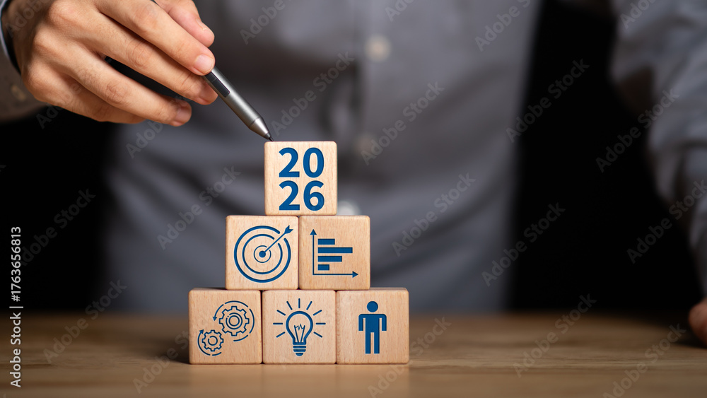 Stacked wooden blocks with icons of target, gear, chart, idea, and ...